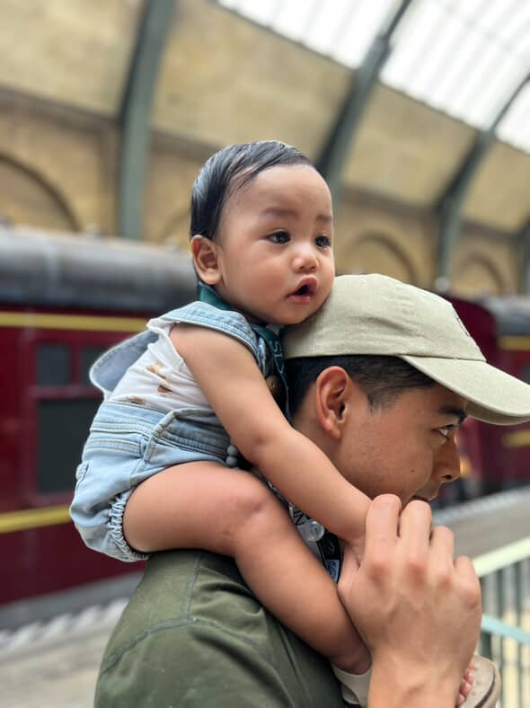 little boy on his dad's shoulder