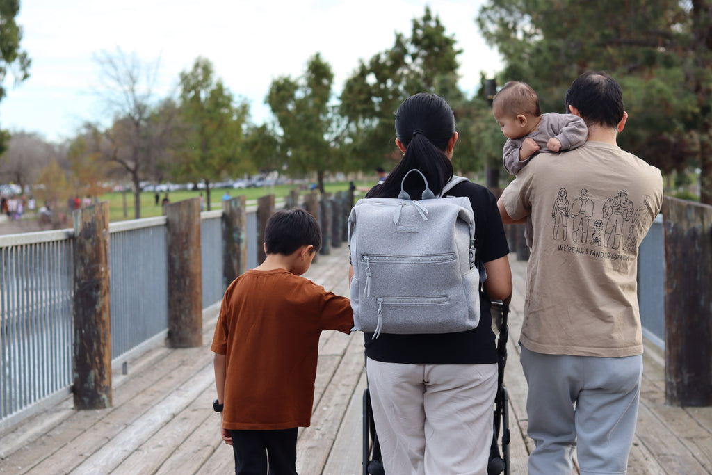 family walking carrying gray bunso neoprene backpack