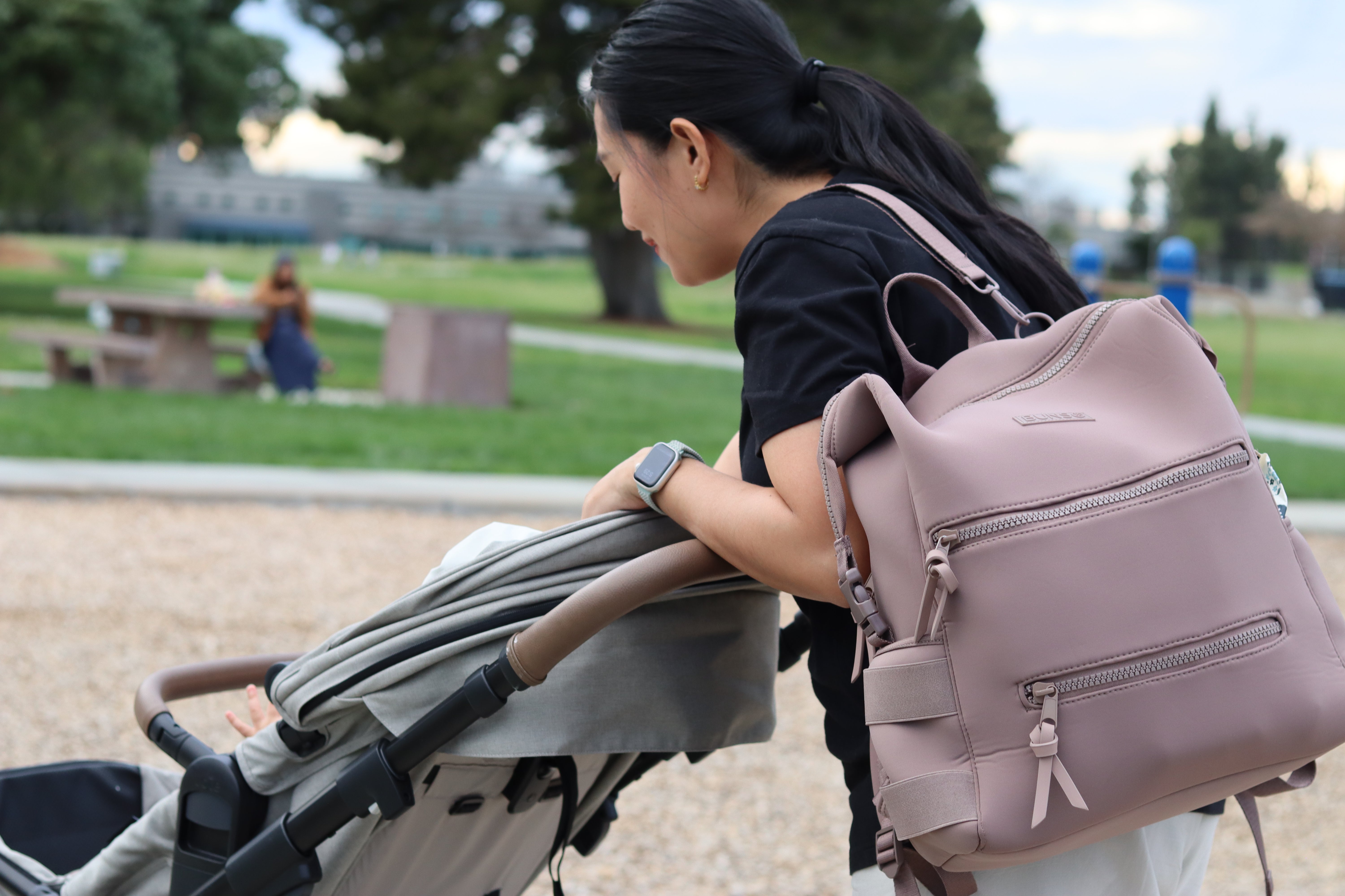 Mom carrying mauve
 bunso neoprene diaper bag